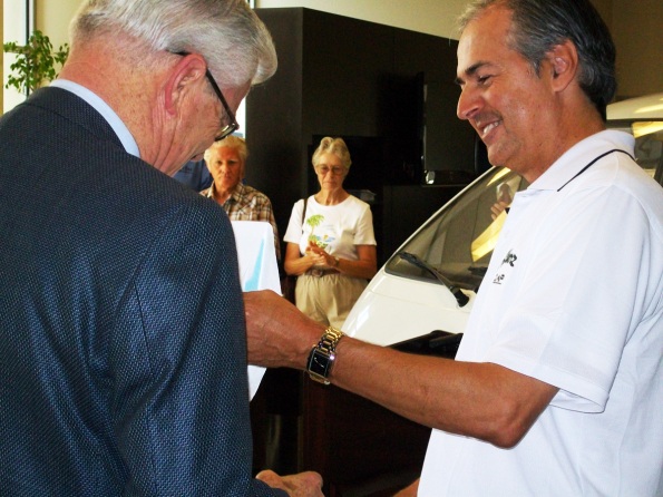 Mayor Ron Loveridge accepts keys to one of the new electric vehicles purchased from Ramon Alvarez, owner of Alvarez ZAP.